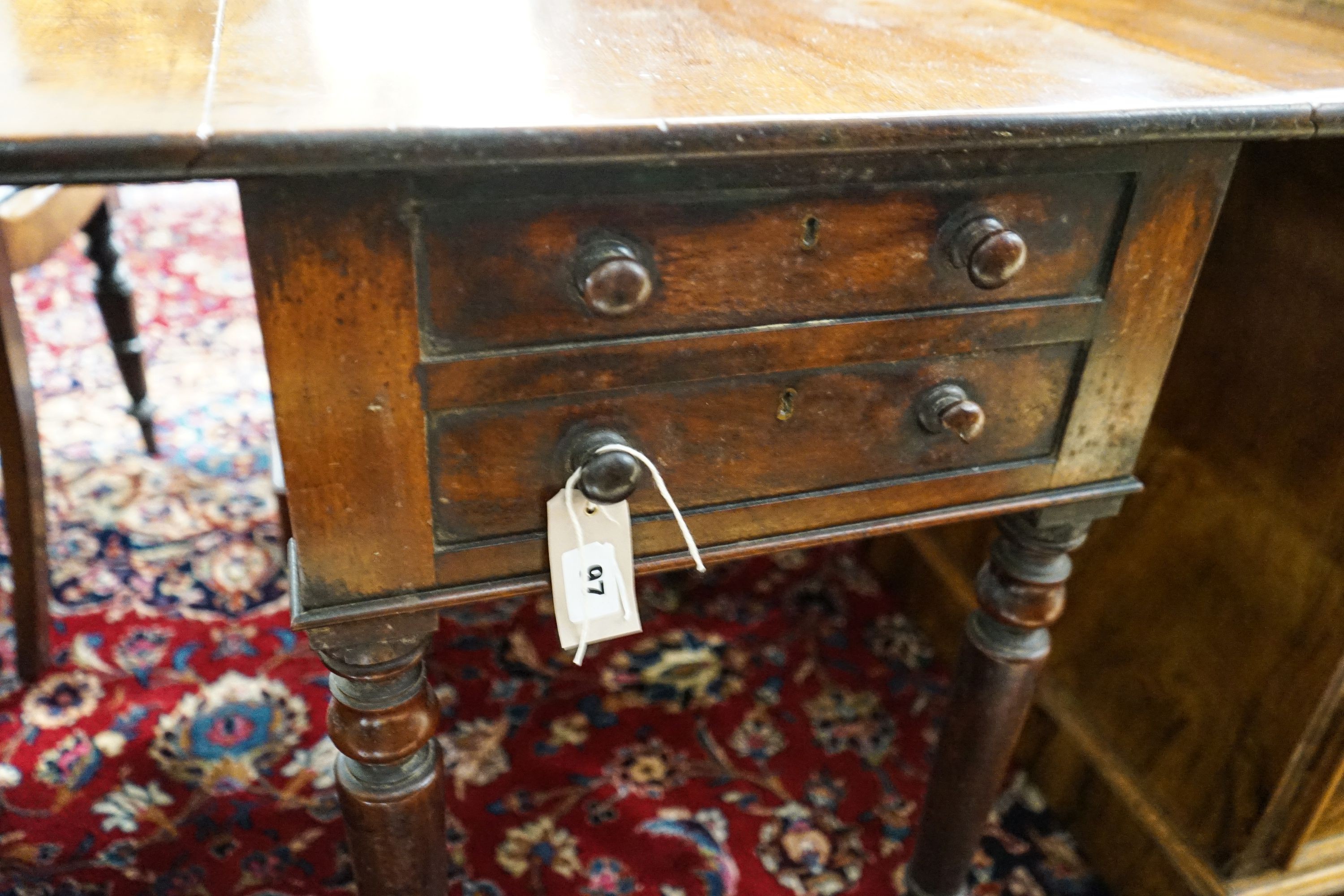 An early Victorian mahogany Pembroke work table, with twin flaps, two drawers, on turned legs and castors, 85cm extended, depth 61cm, height 70cm